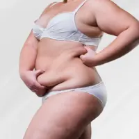 woman holding her extra skin and fat after weight loss as she contemplates body lift costs