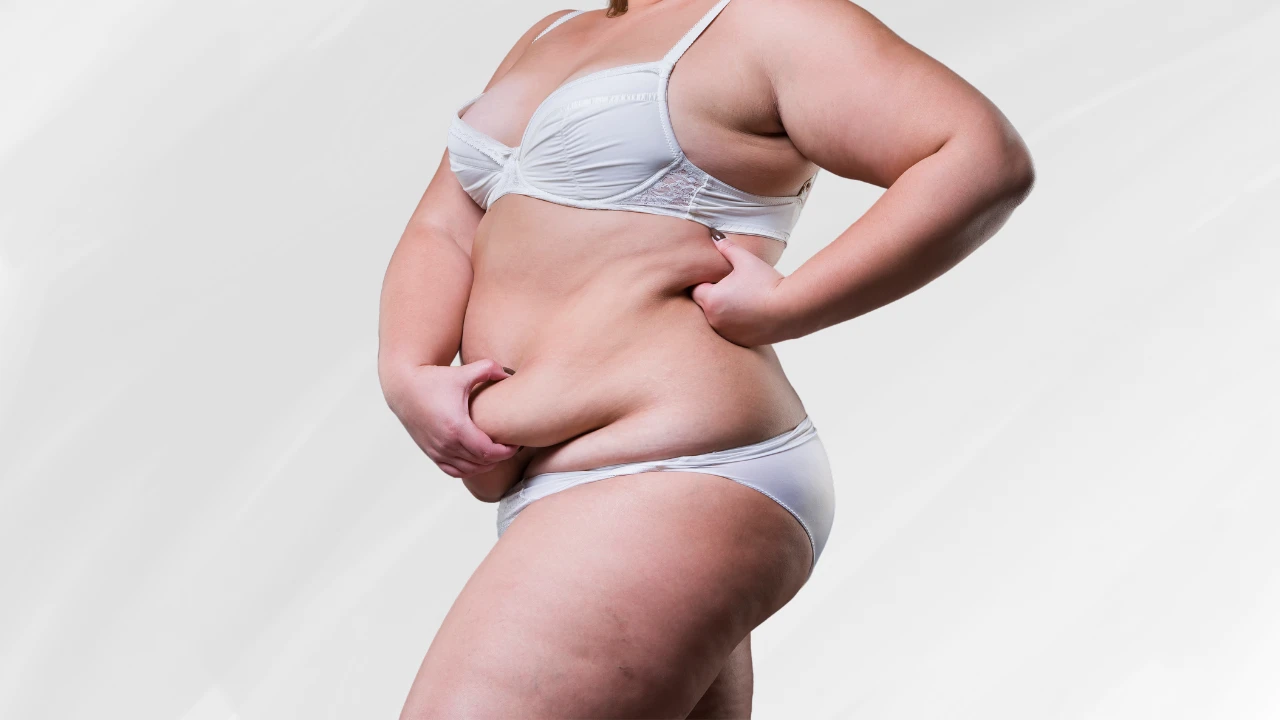 woman holding her extra skin and fat after weight loss as she contemplates body lift costs