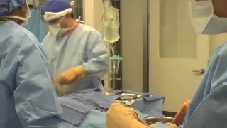 Dr. Rodriguez in the O.R. performing liposuction